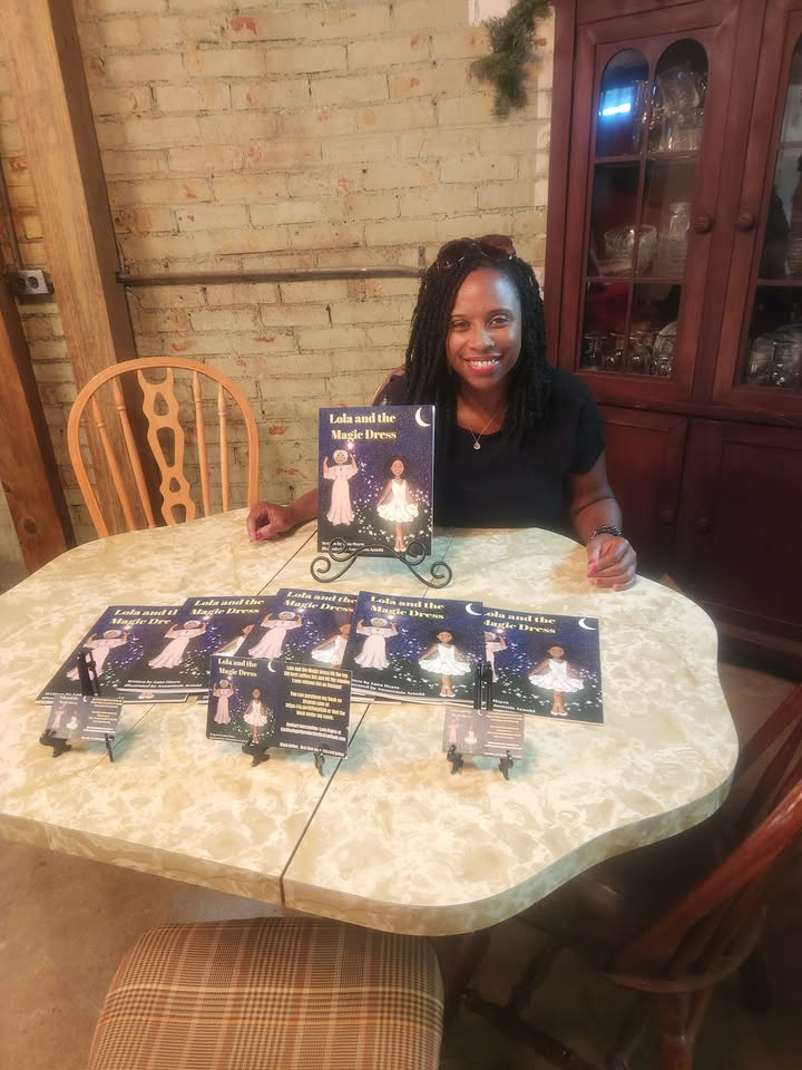 Children's author Lana L. Hayes with copies of Lola and the Magic Dress